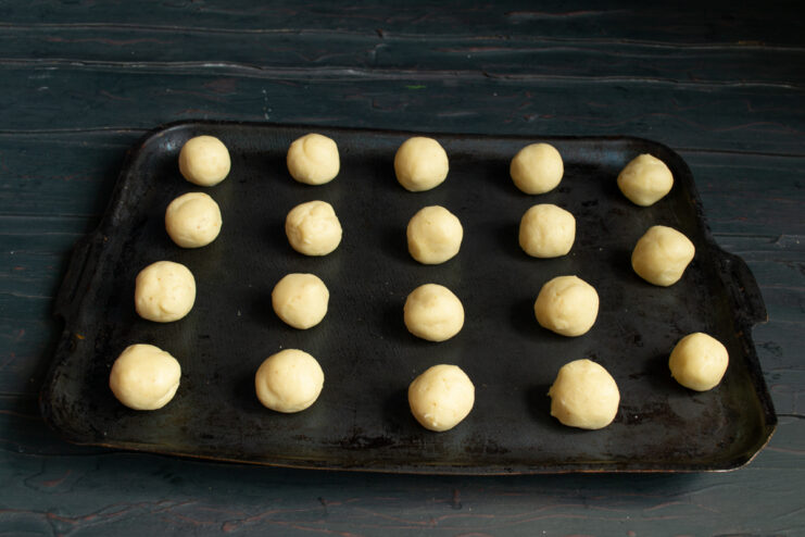 Shaping the cookies Dough balls arranged on a baking sheet