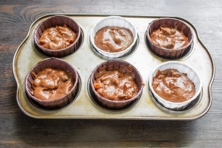Filling The Liners Chocolate batter portioned into paper liners in a muffin tin