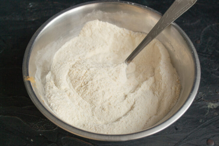 Mixing dry ingredients Blend of almond flour, all-purpose flour, and ground cinnamon in a bowl.