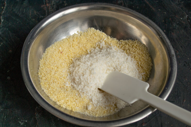 Mixing ground almonds and shredded coconut in a bowl