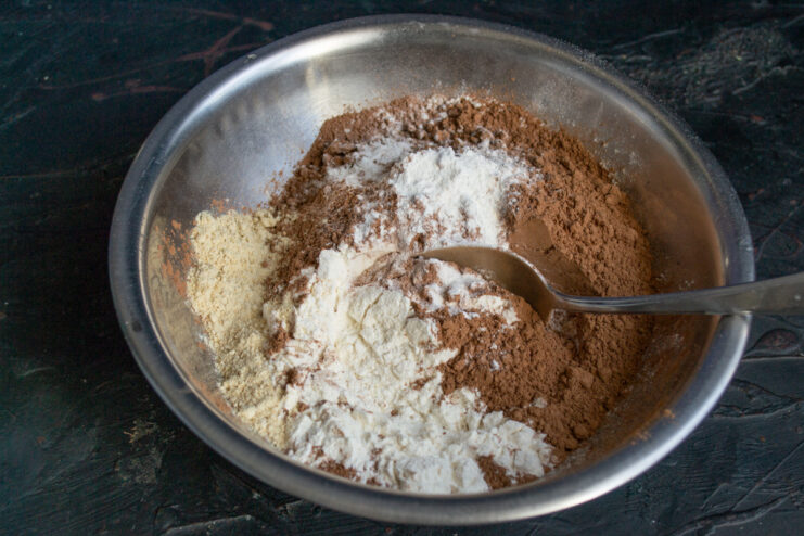 Mixing the Dry Ingredients Mixing flour, cocoa powder, baking powder, and ginger in a bowl