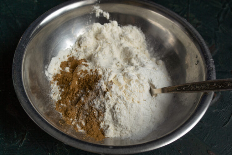 Preparing Dry Ingredients Whisking flour, ground cinnamon, and baking powder in a separate bowl