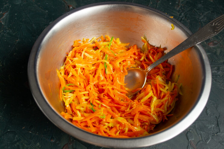Mixing vegetables with soaked bread and scallions