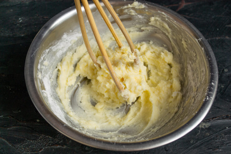 Whipping the butter base Whisking softened butter and powdered sugar.