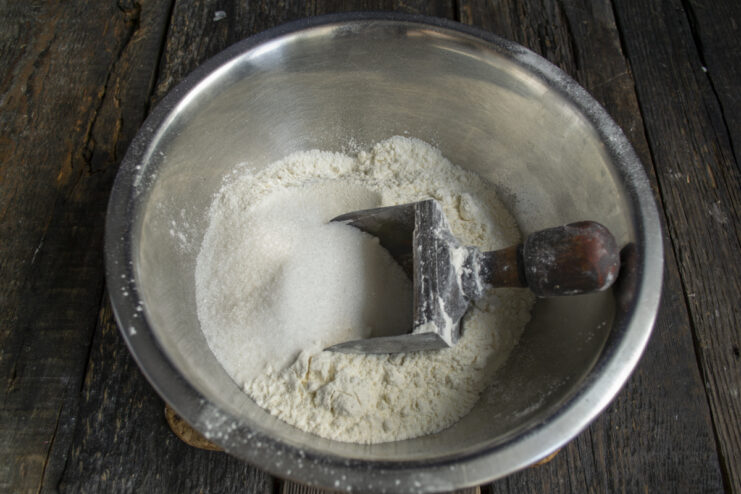 Preparing the Dry Base Mixing dry ingredients for a cake in a glass bowl
