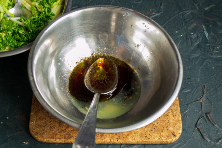 Mixing lime juice, soy sauce, olive oil, and honey in a bowl
