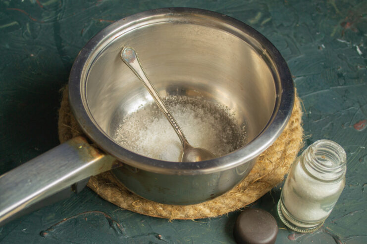 Preparing the marinade base Adding salt, sugar, and citric acid to a saucepan for the marinade