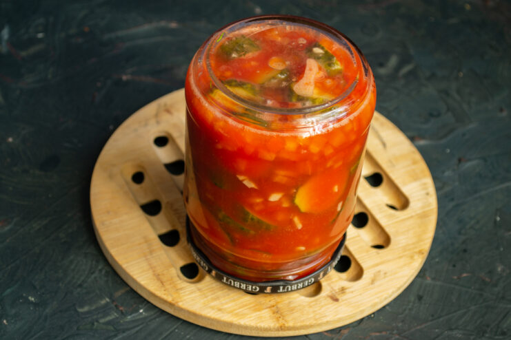 Sealed glass jar of cucumber salad cooling upside down on its lid