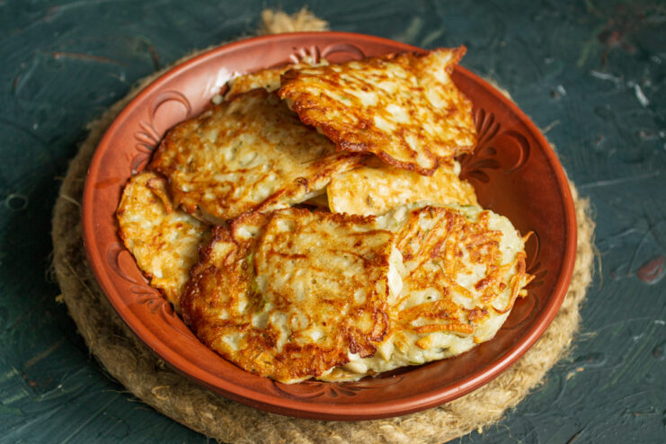 The cooked batch of fritters Stack of freshly fried sunchoke fritters on a ceramic plate