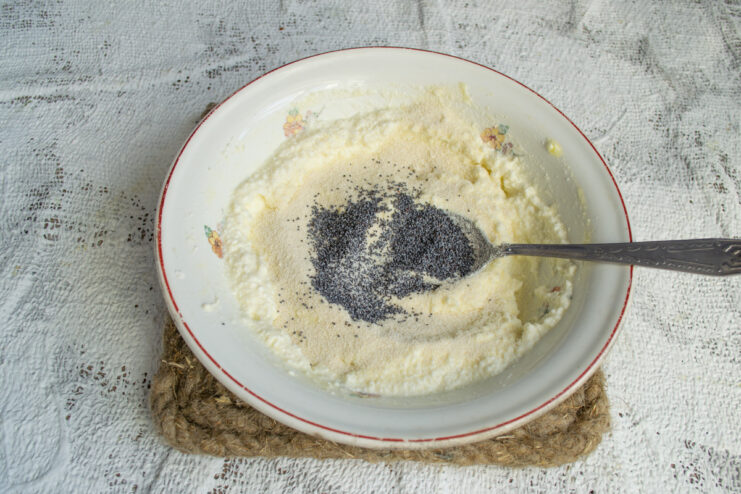 Adding dry poppy seeds Sprinkling dry poppy seeds into the dumpling dough