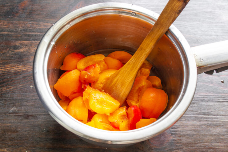 Cooking the Apricots Fresh apricot halves cooking in boiling sugar syrup
