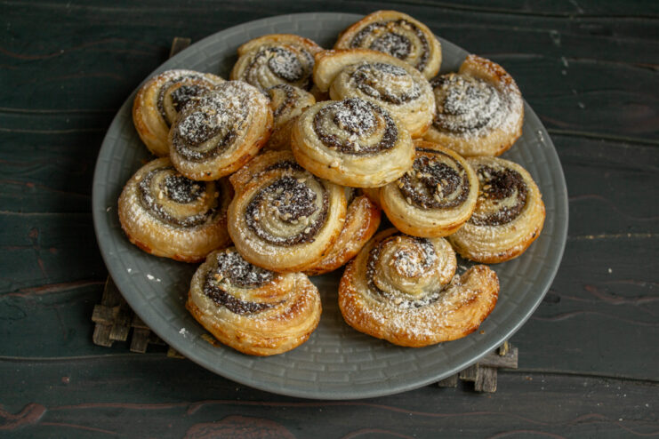 Serving the pinwheels A plate of warm homemade poppy seed puff pastry pinwheels.