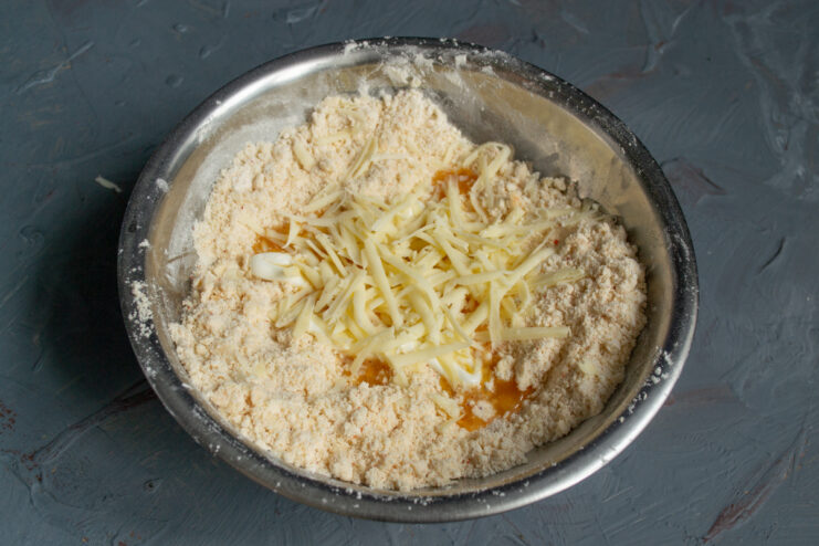 Adding grated cheese Freshly grated hard cheese added to the mixing bowl