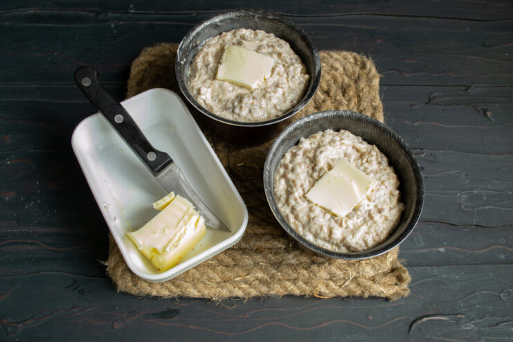 Filling the molds Filled ramekins topped with small pieces of butter