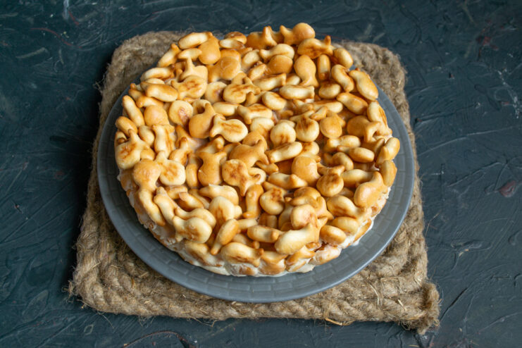 Unmolding the set dessert Unmolded no-bake cracker cake sitting on a flat serving platter