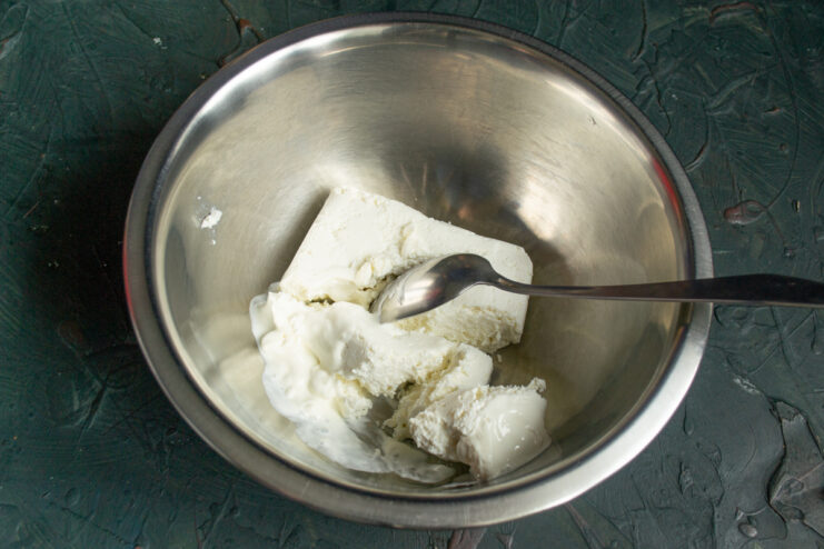 Farmer's cheese and sour cream mixed together in a bowl.