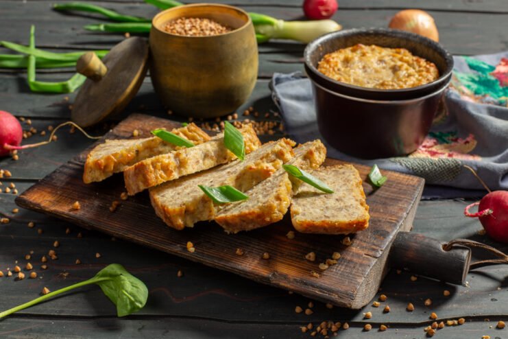 Savory buckwheat and farmers cheese bake served on a wooden cutting board
