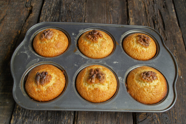 Muffins after baking Golden baked muffins resting in a metal muffin tin
