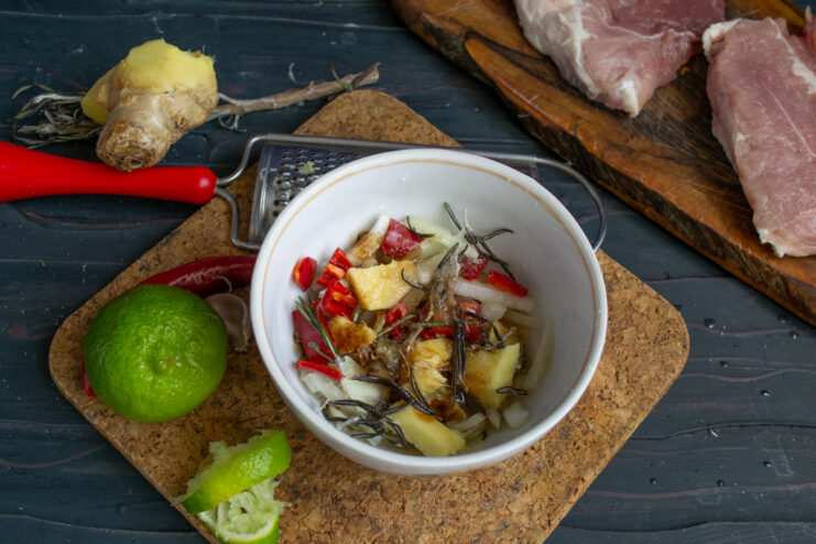 Adding Lime Juice Squeezing fresh lime juice into a bowl with the marinade.