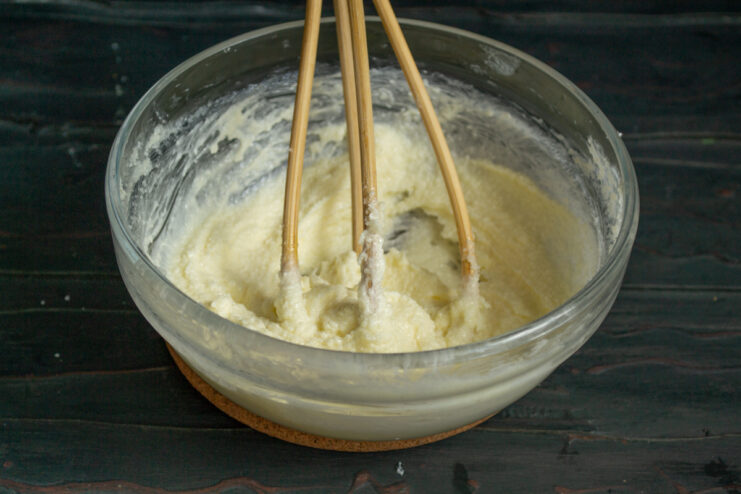Whisking the wet base Whisking ingredients with a wire whisk in a bowl
