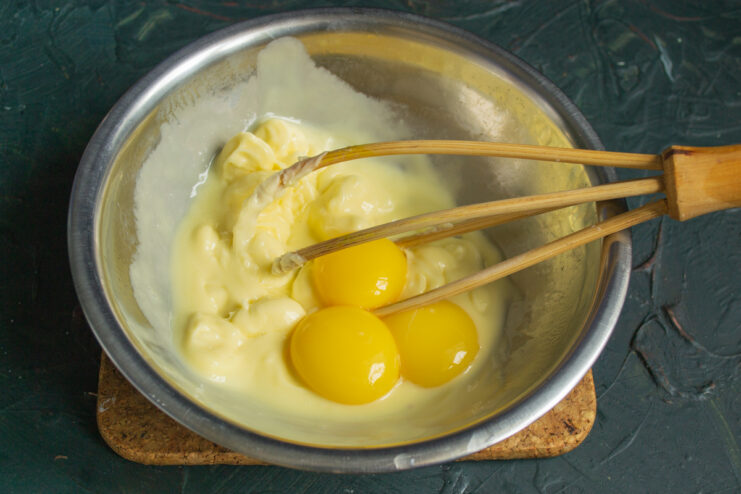 Preparing the butter base Whisking softened butter with egg yolks in a bowl