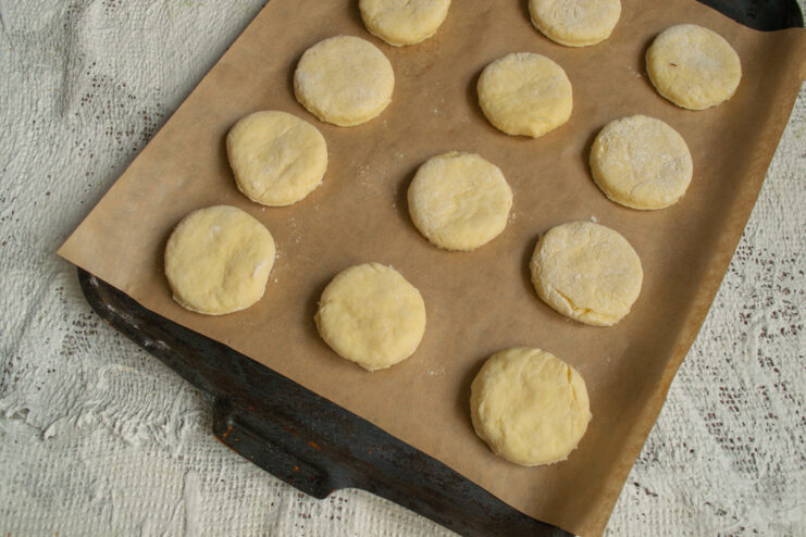 Preparing for baking Raw round cookie shapes arranged on a parchment-lined baking sheet