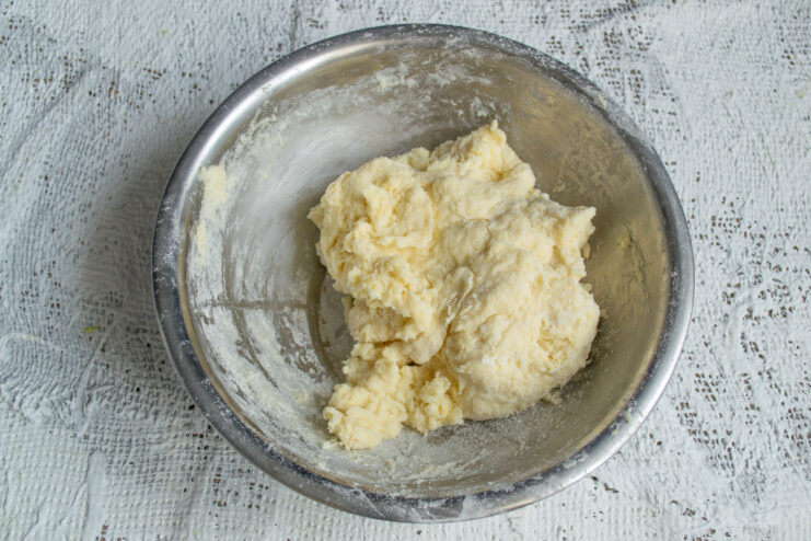Finished Pie Dough Kneaded pie dough resting in a mixing bowl.