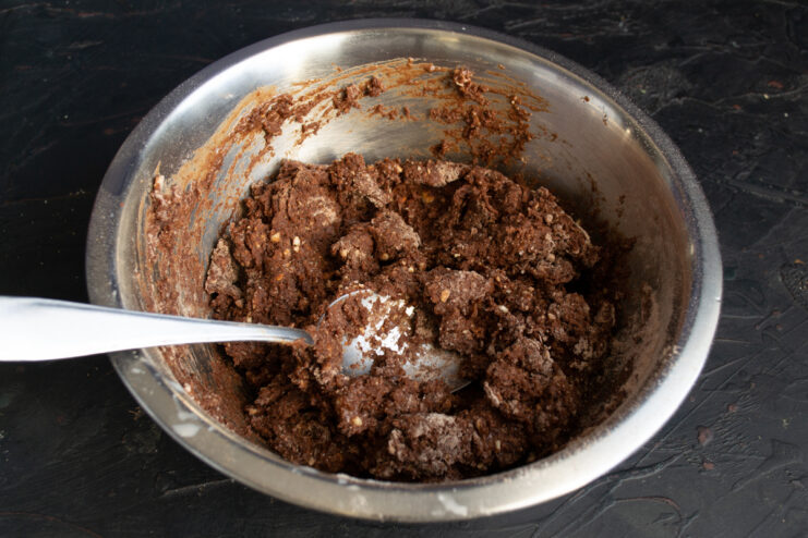 Kneading the Dough Mixing thick and sticky chocolate cookie dough in a bowl
