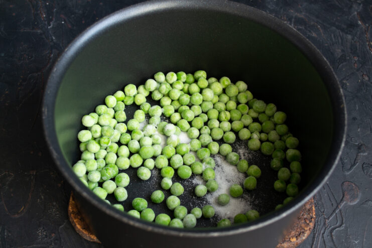 Preparing The Peas Frozen green peas in a saucepan