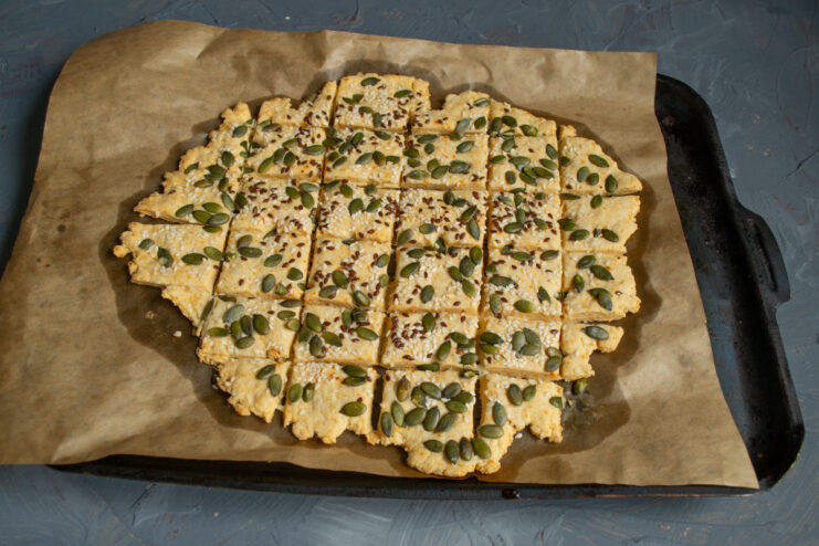 Freshly baked cookies Golden baked cheese cookies resting on a parchment-lined tray
