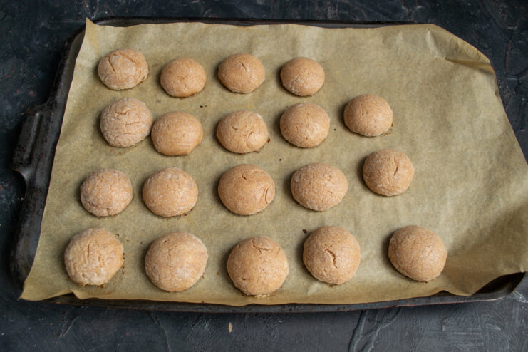 Baking the Halves Freshly baked chocolate cookie halves on a baking sheet