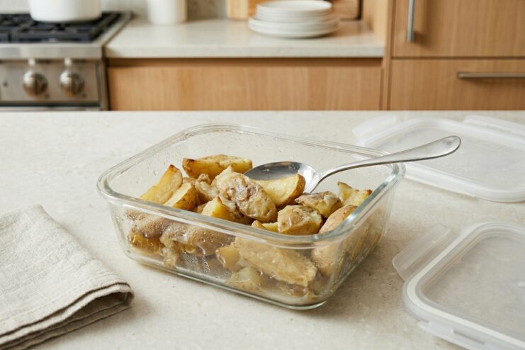 Thawed fried potatoes losing their crisp texture Thawed fried potatoes in a glass container showing a soggy and unappetizing texture