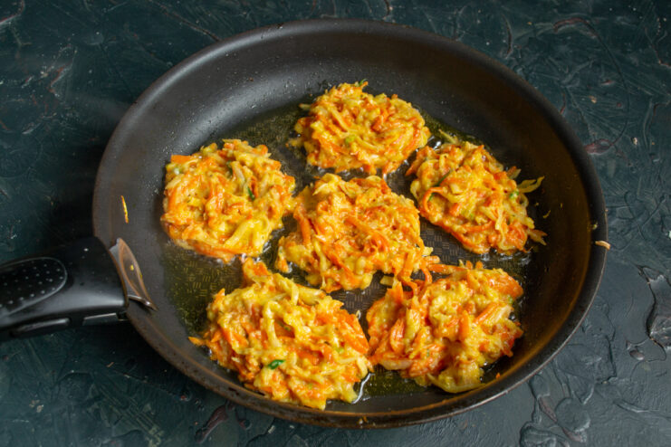 Frying carrot fritters in a hot skillet