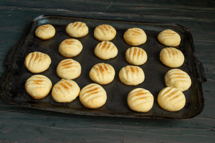 Baked cookies Golden baked cookies on a black baking tray