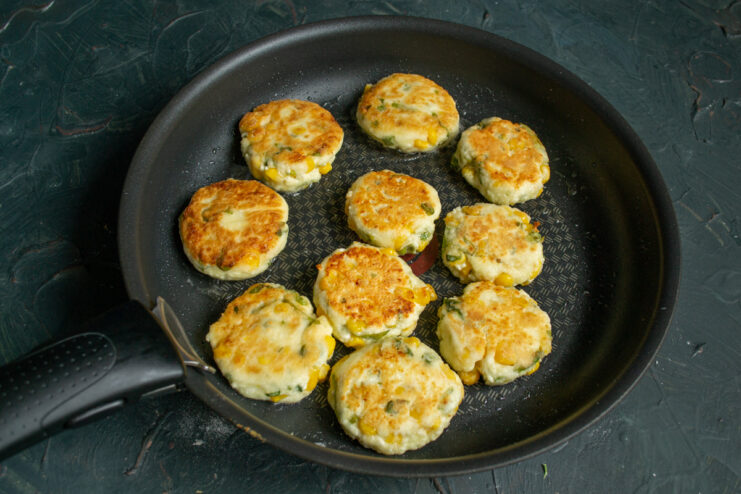 Flipping to achieve a golden crust Golden brown pancakes flipped to the second side in a hot pan