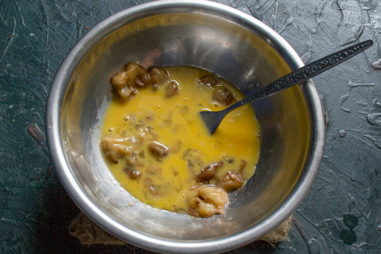 Mashed banana mixed with a raw egg and a pinch of salt