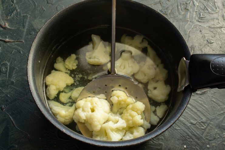 Boiling The Cauliflower Blanching small cauliflower florets in a pot of boiling water