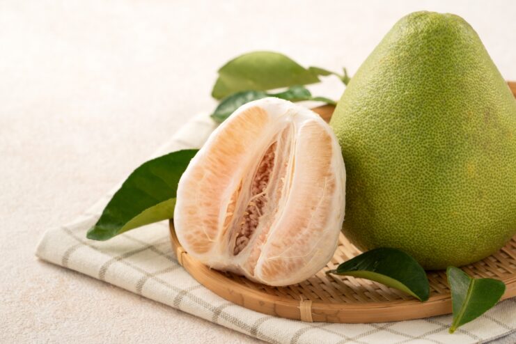 Peeled Pomelo Segments Large pomelo fruit completely peeled revealing thick membrane segments