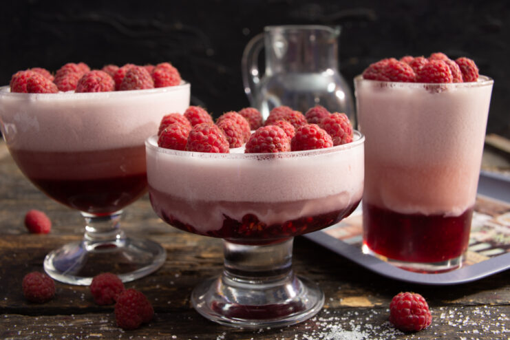 Serving the Milk Jelly Milk jelly dessert topped with whole fresh raspberries