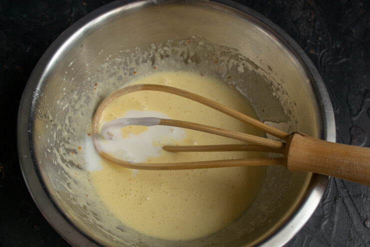 Kefir for the batter Pouring kefir into a mixing bowl with batter