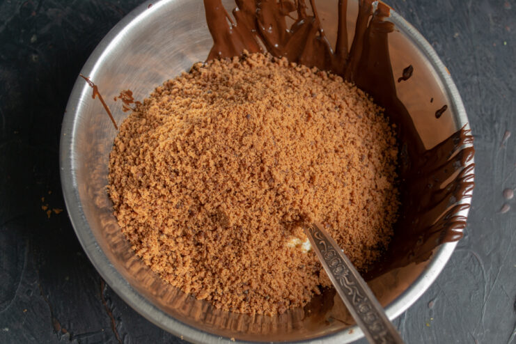 Adding cookie crumbs to the chocolate mascarpone mixture.