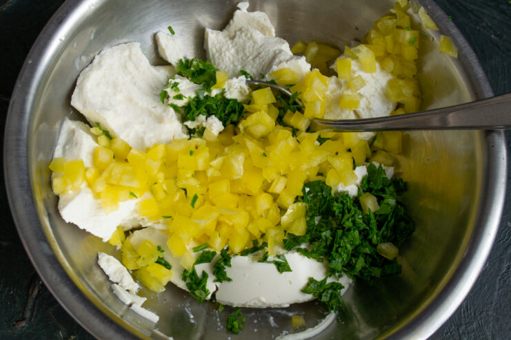 Folding diced yellow bell pepper into the ricotta mixture