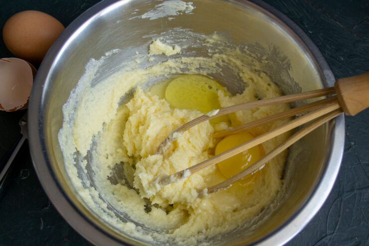 Adding Eggs To The Batter Adding an egg to the creamed butter and sugar mixture