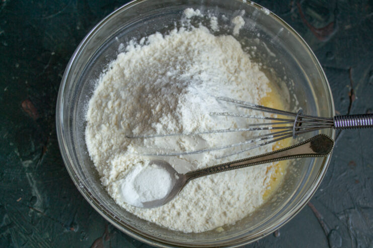 Adding flour and baking powder to the mixing bowl