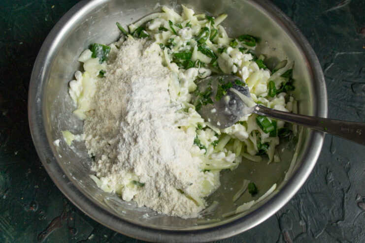 Adding flour mixture Adding flour and baking powder to the vegetable mixture