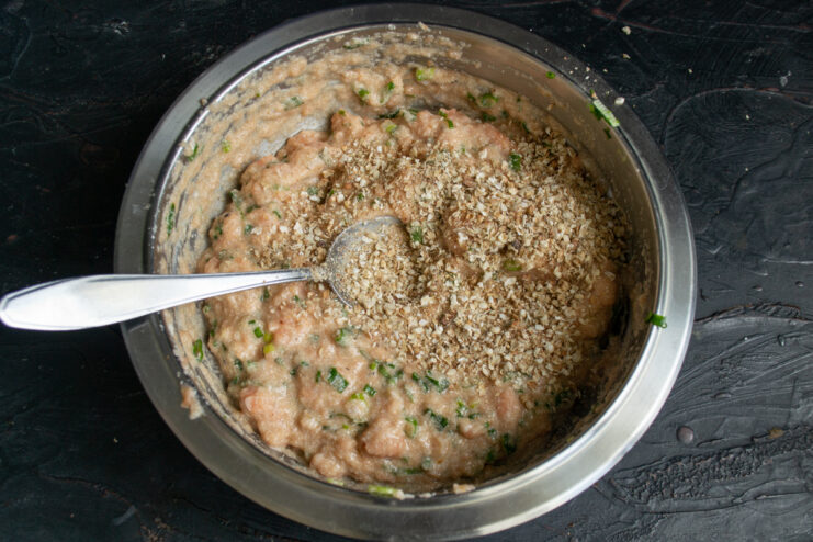 Adding oat flakes Oat flakes added into the seasoned fish mixture.