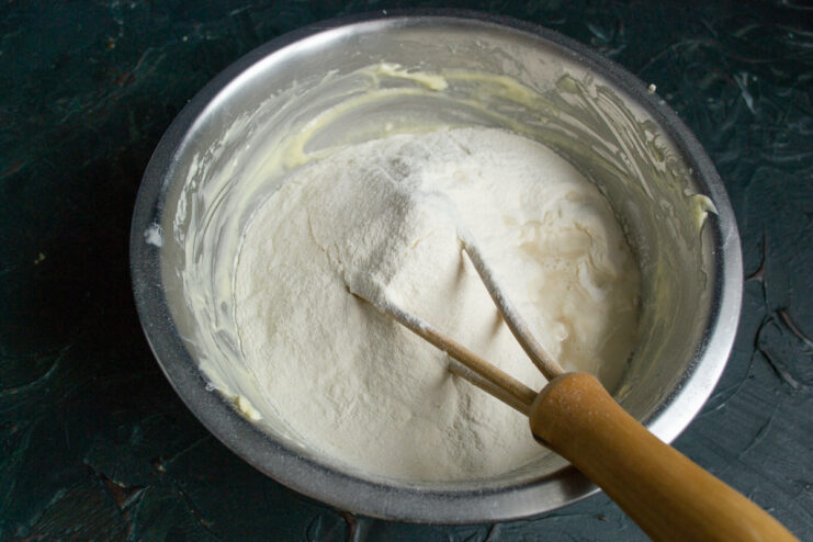 Adding the flour Adding sifted all-purpose flour into the butter mixture