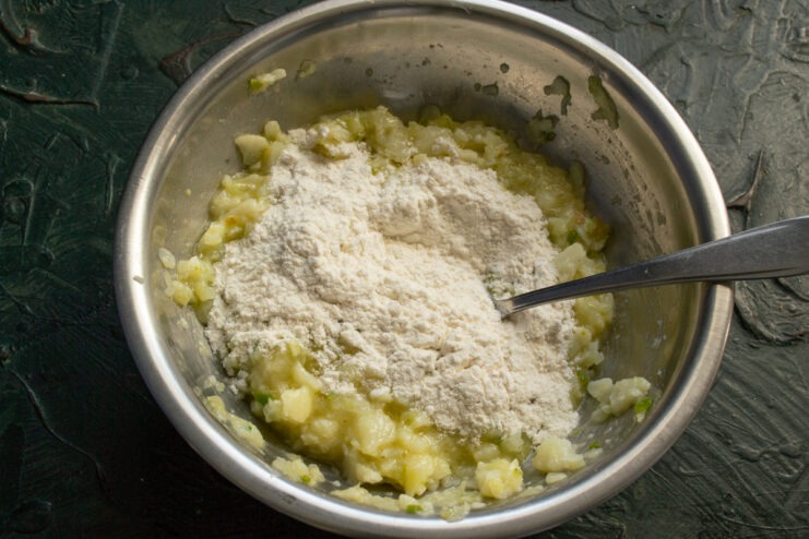 Thickening The Mixture Pouring wheat flour into a bowl with the minced vegetable mixture