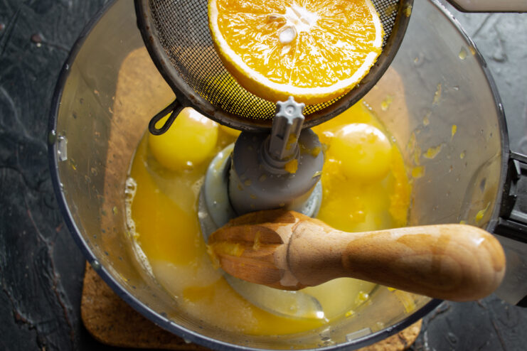 Adding orange juice Pouring freshly squeezed orange juice into a bowl
