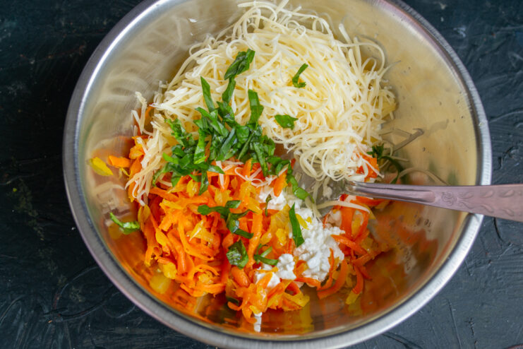 Adding cheese and herbs Stirring grated hard cheese and fresh chopped basil into the filling.